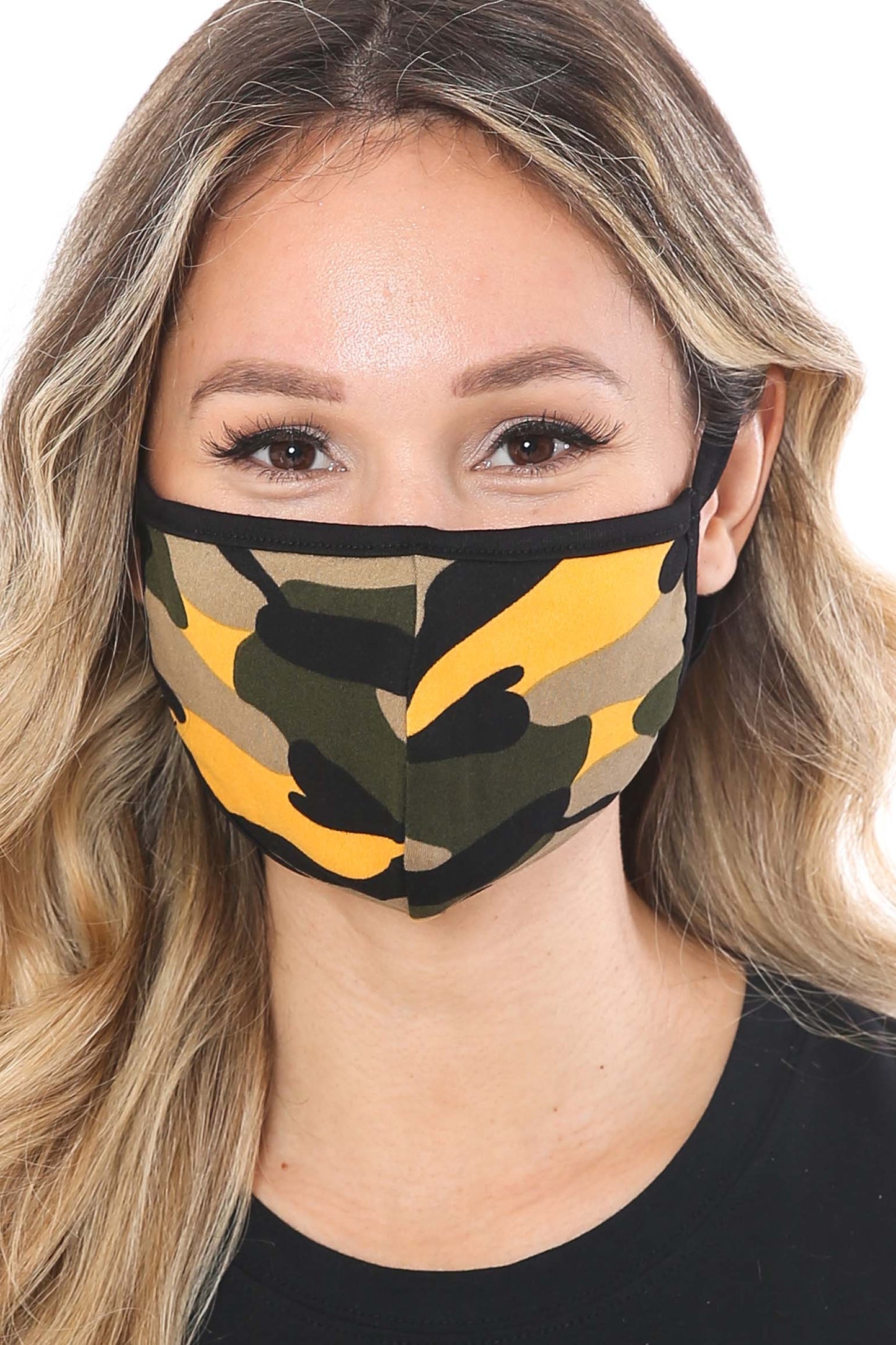 Woman wearing a camouflage face mask with yellow accents